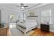 Serene main bedroom features a tray ceiling, hardwood floors, and a comfortable sitting area at 800 Enclave Ter, Summerville, SC 29483