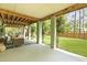 Spacious covered patio with outdoor seating and a view of the beautifully landscaped backyard at 800 Enclave Ter, Summerville, SC 29483