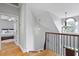Bright staircase with iron railing, hardwood floors, and natural light flowing in from an arched window at 800 Enclave Ter, Summerville, SC 29483