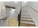 Elegant staircase with wooden steps, white risers, and ornate iron railings at 800 Enclave Ter, Summerville, SC 29483