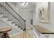 Stylish staircase with wooden steps and iron railing leads to the upper level at 800 Enclave Ter, Summerville, SC 29483