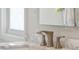 Close up on the sink hardware in the bathroom with a marble countertop and modern faucets at 801 Ventura Pl, Mount Pleasant, SC 29464
