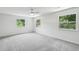 A bright bedroom is freshly painted with new carpet and has three windows with views of the green landscape at 801 Ventura Pl, Mount Pleasant, SC 29464
