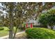 Charming townhome featuring a red front door, lush landscaping, and a mature tree at 801 Ventura Pl, Mount Pleasant, SC 29464