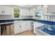 Well-lit kitchen with white cabinets, blue tiled countertops, and modern stainless steel appliances at 801 Ventura Pl, Mount Pleasant, SC 29464