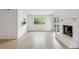 Bright living room featuring a fireplace, window, and screened porch access at 801 Ventura Pl, Mount Pleasant, SC 29464