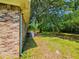 Backyard features a brick exterior, large tree, and an outdoor deck offering serene, private space at 840 Brittle Bank Rd, Walterboro, SC 29488