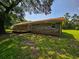 Expansive backyard featuring a brick home, wooden deck, and lush green lawn and a large shaded tree at 840 Brittle Bank Rd, Walterboro, SC 29488
