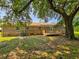 Charming brick home with a wooden deck, and lush greenery with mature trees offering backyard shade at 840 Brittle Bank Rd, Walterboro, SC 29488