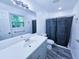 Modern bathroom with sleek vanity, updated fixtures, new window, and a shower with curtain at 840 Brittle Bank Rd, Walterboro, SC 29488