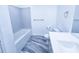 Bathroom features a large bathtub, modern vanity, and gray marbled floors at 840 Brittle Bank Rd, Walterboro, SC 29488