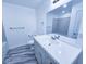 Bathroom with modern vanity, large mirror, and gray marbled floors for a spa-like retreat at 840 Brittle Bank Rd, Walterboro, SC 29488