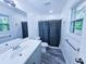 Stylish bathroom with new vanity, shower with curtain, updated fixtures, and a large window at 840 Brittle Bank Rd, Walterboro, SC 29488