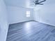 Bright bedroom with gray flooring, ceiling fan, large window and double closet doors at 840 Brittle Bank Rd, Walterboro, SC 29488