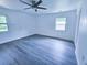 Spacious bedroom with new gray flooring, a ceiling fan, and dual windows for ample natural light at 840 Brittle Bank Rd, Walterboro, SC 29488