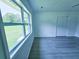 Bright bedroom featuring new gray flooring, a large window, and a spacious closet for ample storage at 840 Brittle Bank Rd, Walterboro, SC 29488