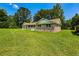 Brick home with a well-kept lawn and detached garage with a sunny sky in the background at 840 Brittle Bank Rd, Walterboro, SC 29488