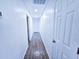 Hallway with hardwood floors and white doors leads to the home's bedrooms and bathrooms at 840 Brittle Bank Rd, Walterboro, SC 29488