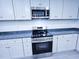 Contemporary kitchen with stainless steel appliances and stylish gray countertops and cabinets at 840 Brittle Bank Rd, Walterboro, SC 29488