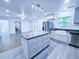 Bright kitchen with gray cabinets, center island, stainless steel appliances, and natural light at 840 Brittle Bank Rd, Walterboro, SC 29488