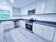 Bright kitchen featuring granite countertops, stainless steel appliances, and a farmhouse sink at 840 Brittle Bank Rd, Walterboro, SC 29488