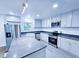 Beautiful kitchen features stainless appliances, an island, granite countertops, and white cabinets at 840 Brittle Bank Rd, Walterboro, SC 29488