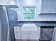 Kitchen features new stainless steel appliances, modern sink and window overlooking a serene backyard at 840 Brittle Bank Rd, Walterboro, SC 29488