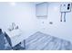 Bright laundry room with new water heater, utility sink and washer-dryer hookups at 840 Brittle Bank Rd, Walterboro, SC 29488