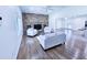 Spacious living room features a brick fireplace and an open floor plan with abundant light and hardwood floors at 840 Brittle Bank Rd, Walterboro, SC 29488