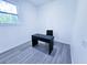 Home office with grey wood floors, white walls, and a modern desk and chair at 840 Brittle Bank Rd, Walterboro, SC 29488