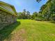 View of the green grass surrounding the back of the house and the beautiful trees at 840 Brittle Bank Rd, Walterboro, SC 29488