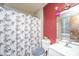 Bathroom with a toilet, sink, and shower with patterned curtain at 1004 Miles Jamison Rd, Summerville, SC 29485