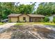 Charming one-story home with a brick and siding facade, an attached garage, and a front yard with landscaping at 1004 Miles Jamison Rd, Summerville, SC 29485