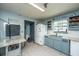 This kitchen includes a refrigerator, double sink, and a blue accent wall at 1004 Miles Jamison Rd, Summerville, SC 29485
