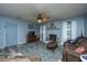 Cozy living room with a brick fireplace, ceiling fan, hardwood floors, and comfortable seating at 1004 Miles Jamison Rd, Summerville, SC 29485