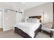Serene bedroom featuring a comfortable bed, a ceiling fan, and a sliding barn door for a modern touch at 1014 Rosewood Ln, Mount Pleasant, SC 29464
