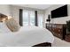 Inviting bedroom with a large window, TV, and an elegant dresser with decorative accents at 1014 Rosewood Ln, Mount Pleasant, SC 29464