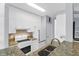Well-lit kitchen with white appliances and cabinets, granite countertops, tile backsplash and stainless steel sink at 1014 Rosewood Ln, Mount Pleasant, SC 29464