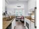 Modern kitchen showcasing granite countertops, stainless steel sink, white cabinetry and a breakfast nook at 1014 Rosewood Ln, Mount Pleasant, SC 29464