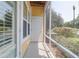 Enclosed porch with yellow siding, a white door, and serene garden views at 1014 Rosewood Ln, Mount Pleasant, SC 29464
