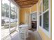 Covered outdoor porch with a table and chairs, offering a peaceful spot to relax at 1014 Rosewood Ln, Mount Pleasant, SC 29464