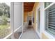 A cozy outdoor porch with white accents, overlooking the garden and providing a serene spot to unwind at 1014 Rosewood Ln, Mount Pleasant, SC 29464