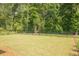 Spacious backyard with verdant lawn, privacy fence, and view of mature shade trees at 1030 Grace Field Ave, Summerville, SC 29485