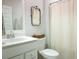 Bright bathroom with a vanity, toilet, tub, and shower with a neutral-colored shower curtain at 1030 Grace Field Ave, Summerville, SC 29485