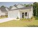 Inviting single-Gathering home boasting a two-car garage, a concrete driveway, and lovely landscaping at 1030 Grace Field Ave, Summerville, SC 29485