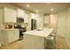 Modern kitchen featuring white cabinets, stainless steel appliances, and a center island with bar stools at 1030 Grace Field Ave, Summerville, SC 29485