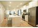 Bright open kitchen featuring white cabinets, stainless steel appliances, and a quartz countertop island with bar seating at 1030 Grace Field Ave, Summerville, SC 29485