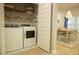 Modern laundry room with white washer and dryer visible next to a dining area at 1030 Grace Field Ave, Summerville, SC 29485