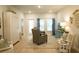 Cozy living room with light hardwood floors, area rug, and comfortable seating with light-filled windows at 1030 Grace Field Ave, Summerville, SC 29485