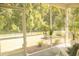 Relaxing screened porch featuring a view of the manicured lawn and lush, mature trees at 1030 Grace Field Ave, Summerville, SC 29485